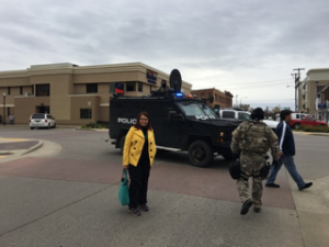 Sarah standing in front of law enforcement vehicle