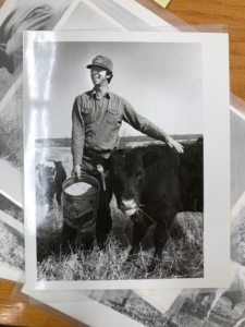 photo of farmer Dwight Coleman smiling next to cattle